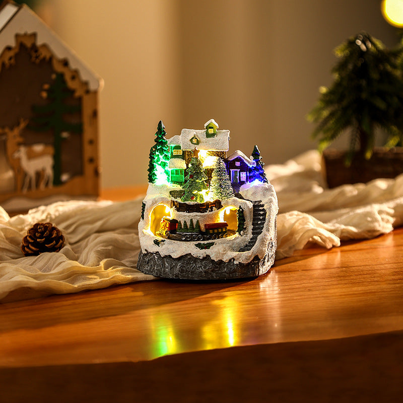 Illuminated Christmas village scene with snowman