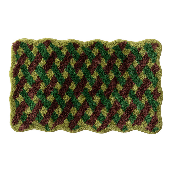 Tufted bathroom runner with wavy hem and relief-style braided pattern