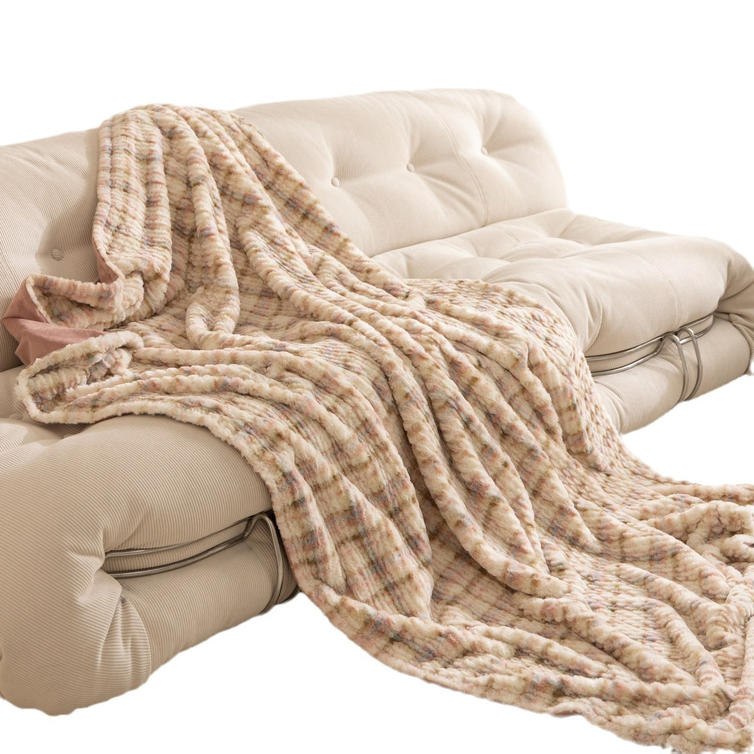 Cozy blanket made of luxurious synthetic fur with wavy texture and soft microfiber back