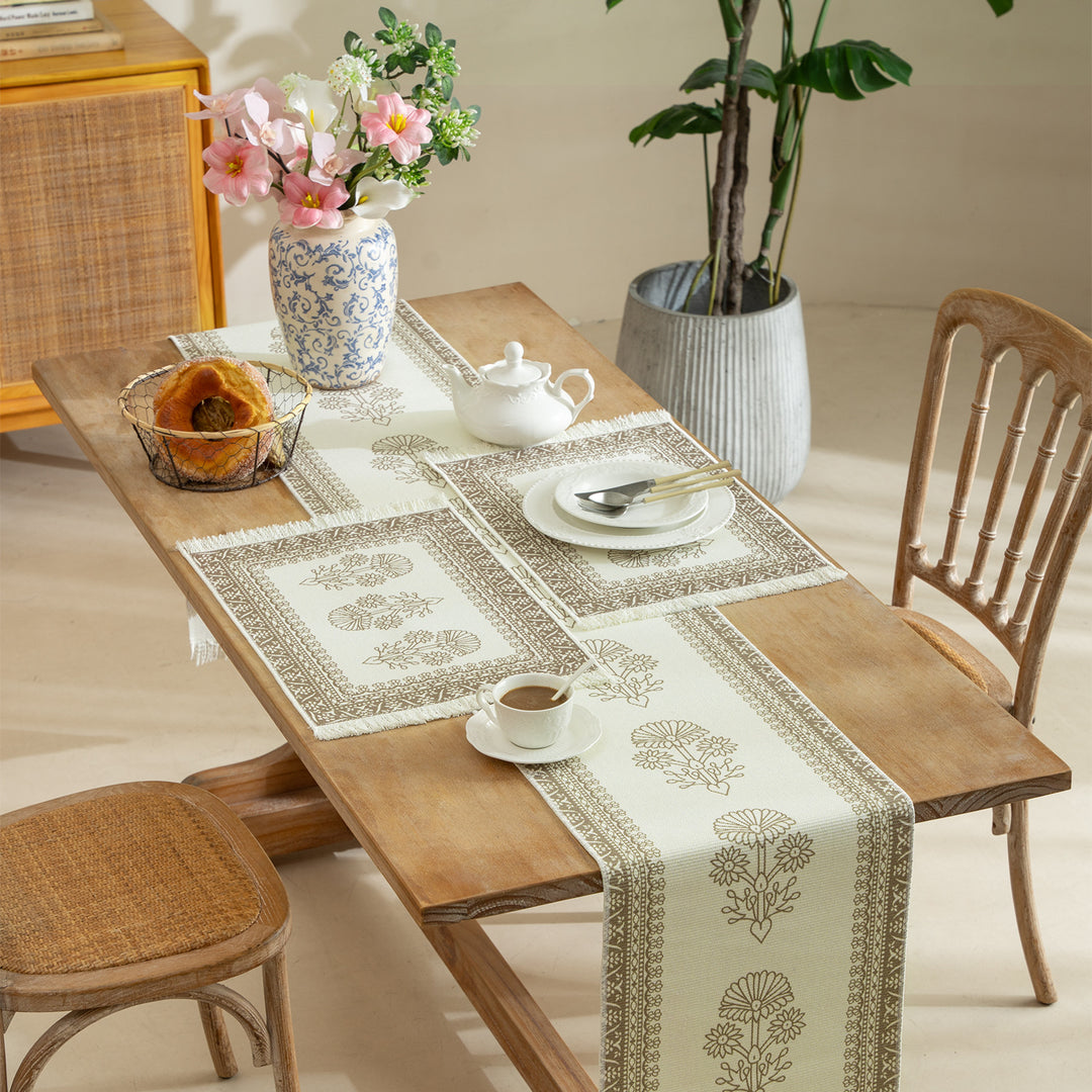 Vintage-inspired woven table runner with floral border and fringes