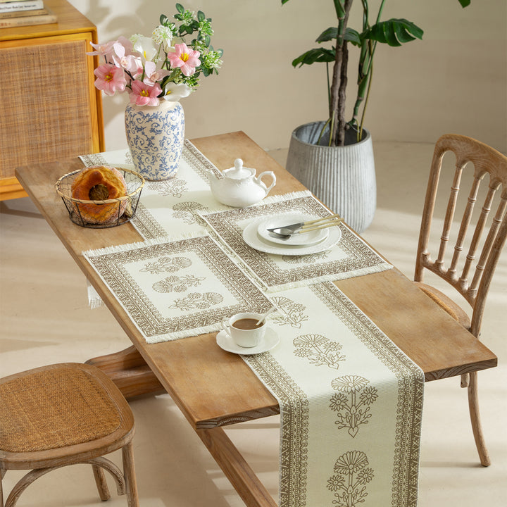 Vintage-inspired woven table runner with floral border and fringes