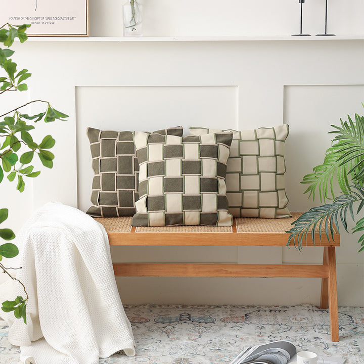 Decorative cushion cover with woven grid relief and contrasting piping