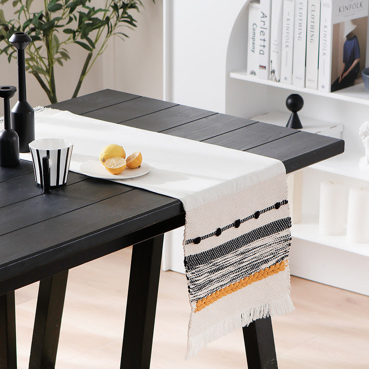 Woven cotton table runner with boho stripes, fringes, and textured woven edge