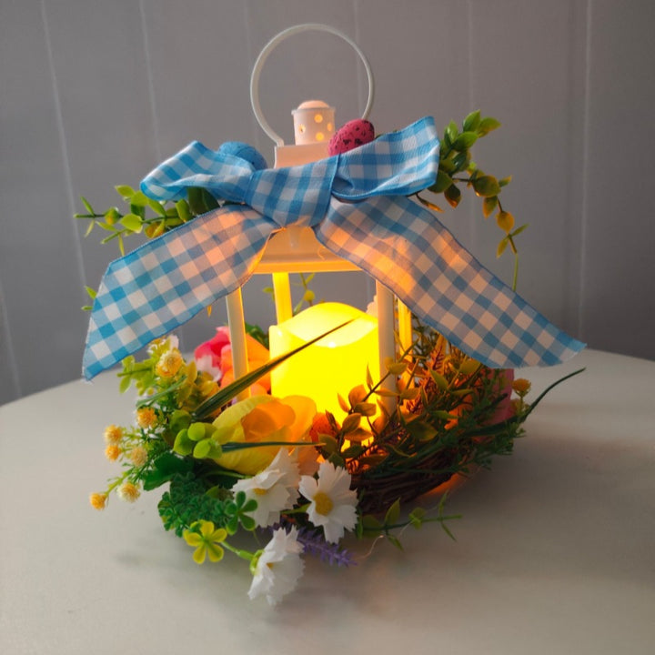 Decorative table lantern with artificial flowers and ribbon