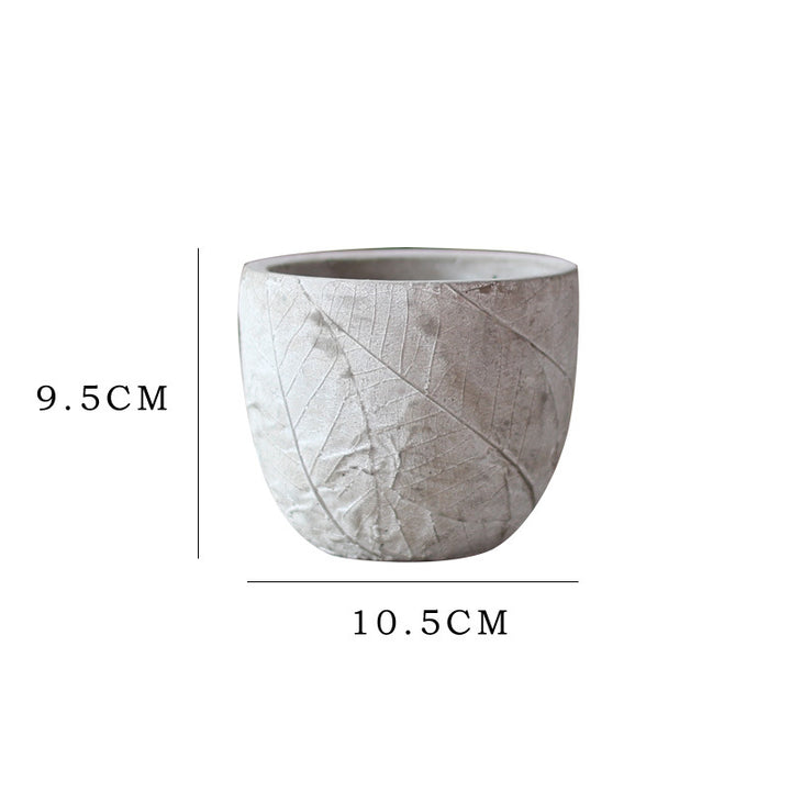 Decorative plant container made of handmade ceramic with leaf pattern