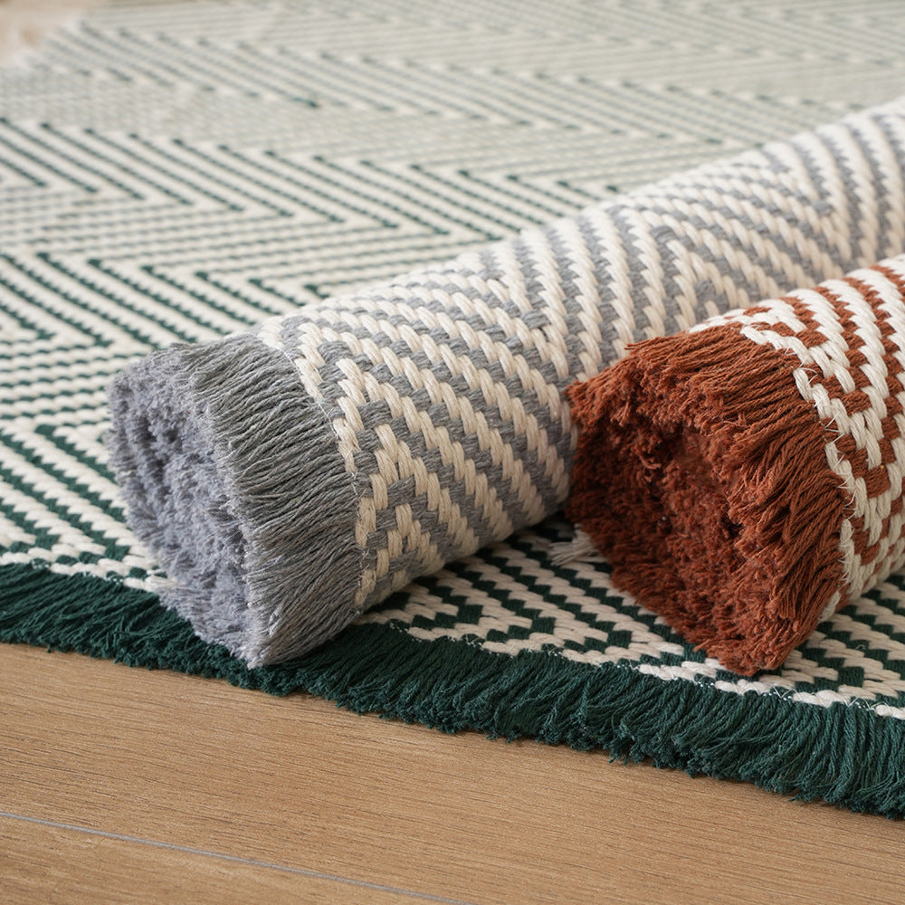 Handwoven cotton bath mat with herringbone pattern and fringes