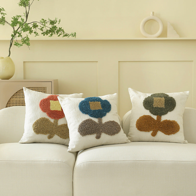 Decorative tufted cushion cover with hand-tufted flower applique
