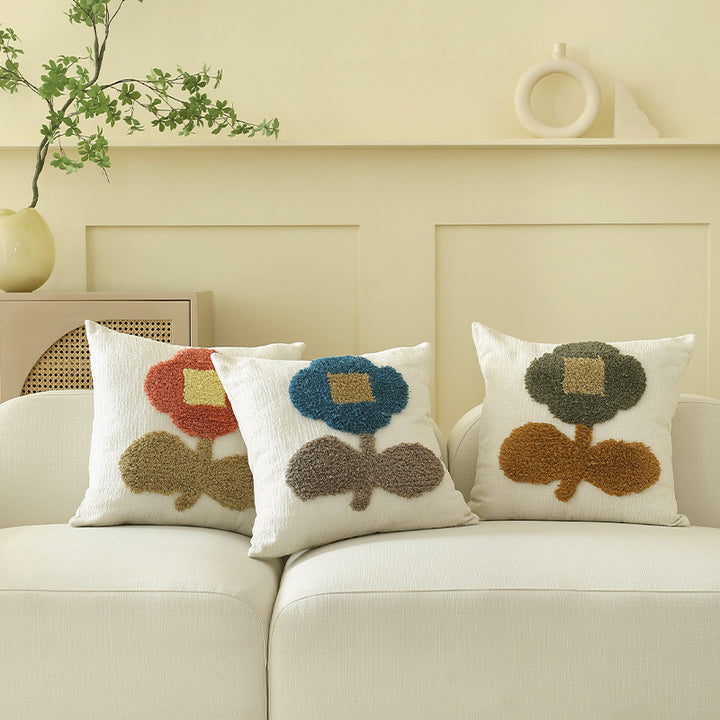 Decorative tufted cushion cover with hand-tufted flower applique