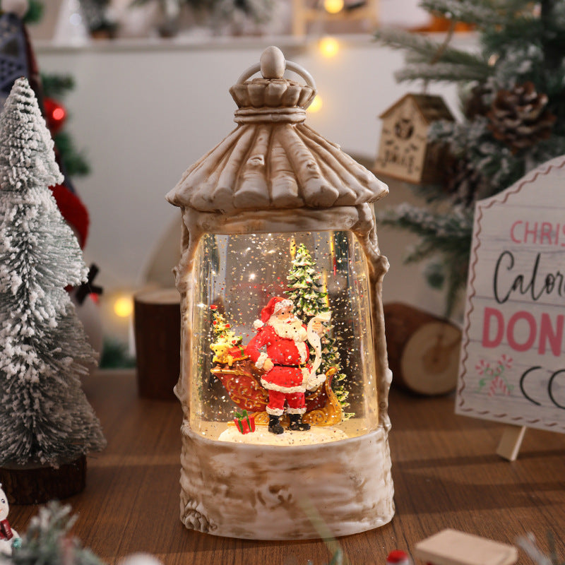 Illuminated Christmas lantern with snow scenes