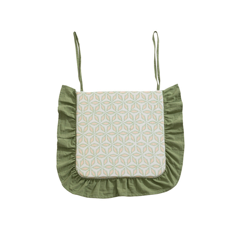 Padded chair cushion with ties, ruffled edge and embroidered hole pattern look