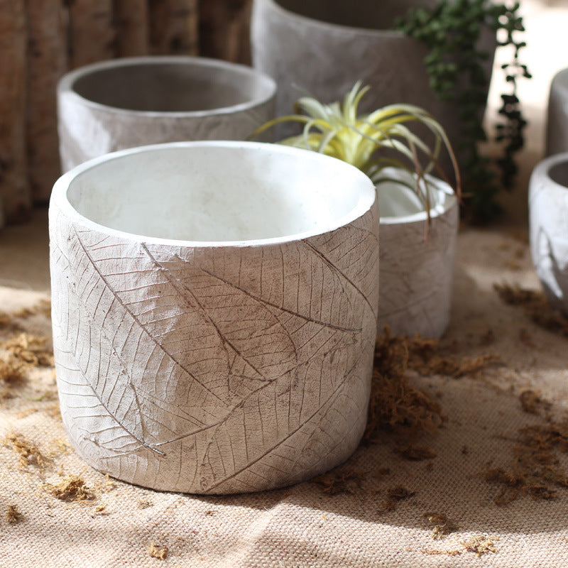 Decorative plant container made of handmade ceramic with leaf pattern