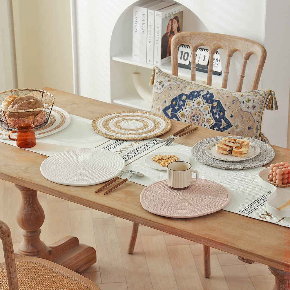 Braided round table mat made of cotton rope and sea grass with spiral structure