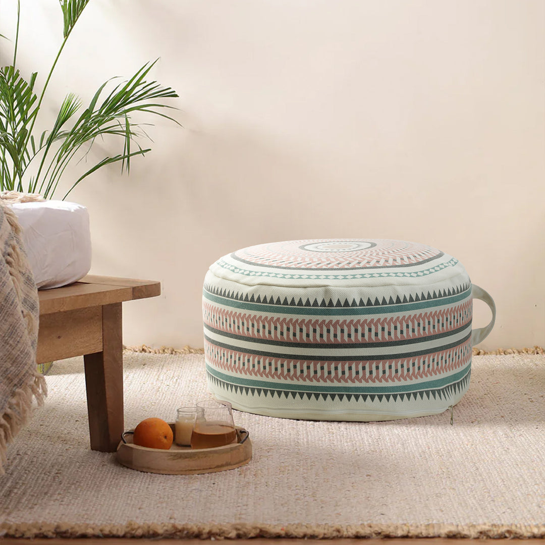Round padded floor seat pouf with woven ethnic pattern and carrying handle
