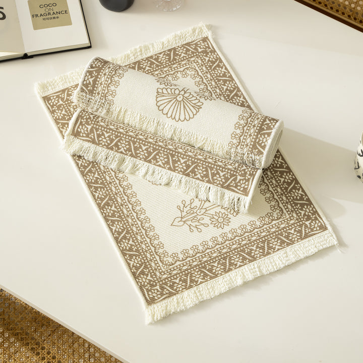 Round handmade woven decorative rug with fringes and botanical pattern