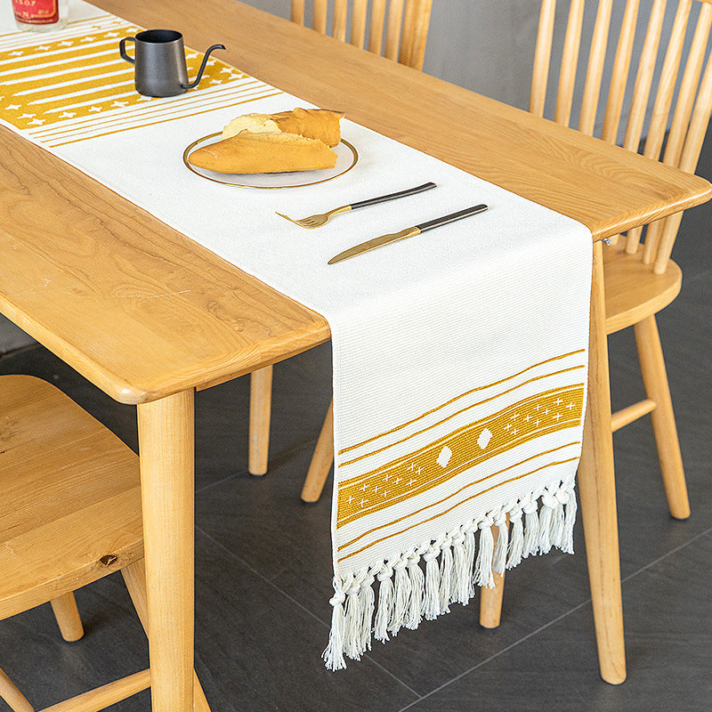 Woven Boho table runner made of cotton blend with decorative fringes and graphic stripe pattern
