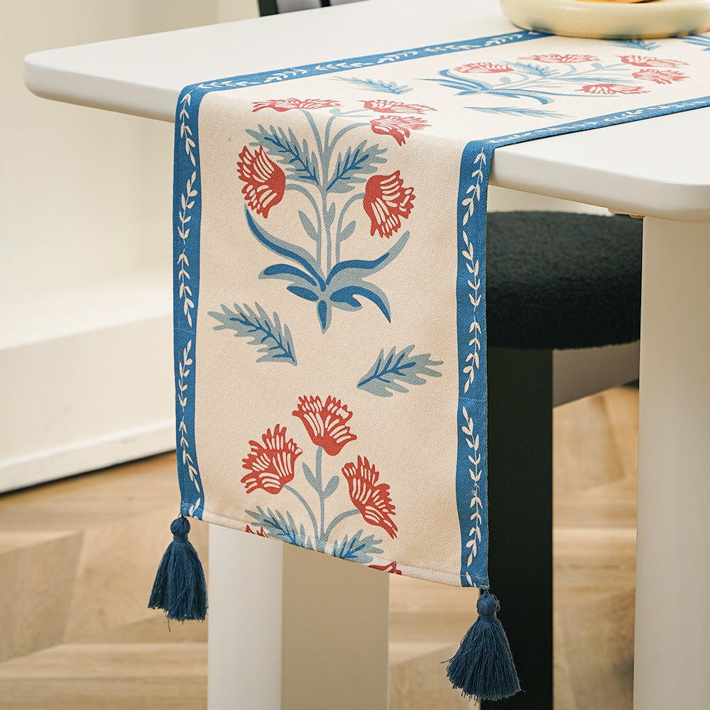 Table runner made of linen blend with floral block print motifs and tassels