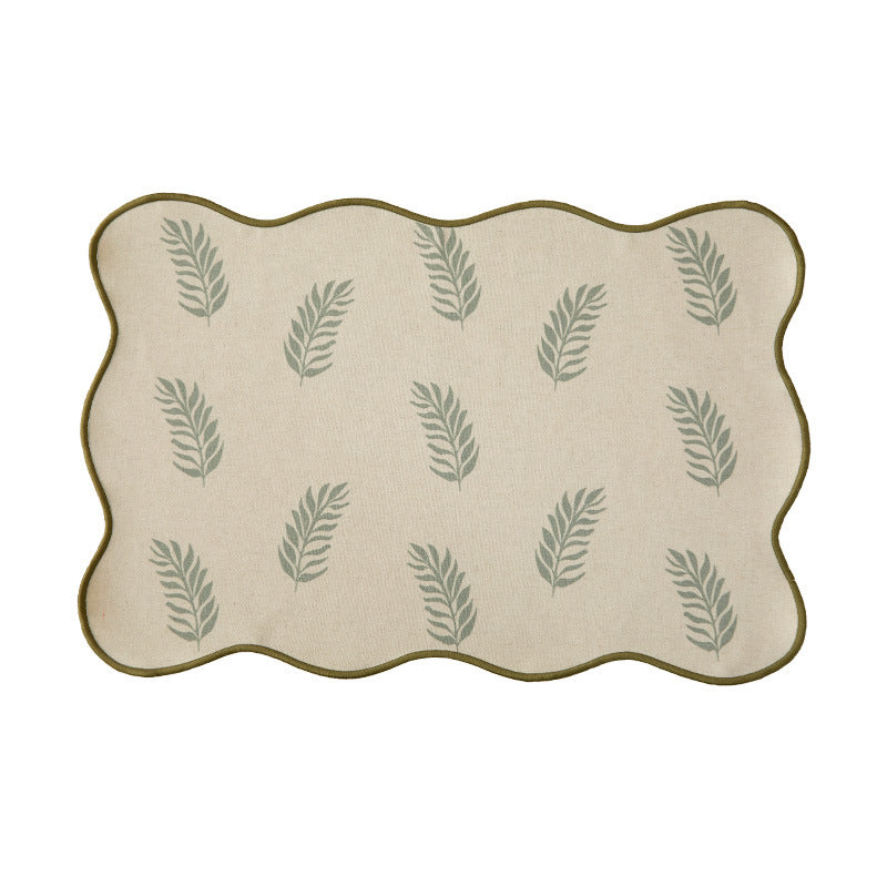Shaped placemat made of cotton-linen with wavy edge and leaf pattern