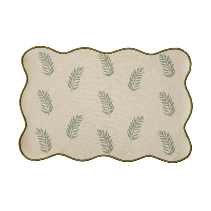 Shaped placemat made of cotton-linen with wavy edge and leaf pattern
