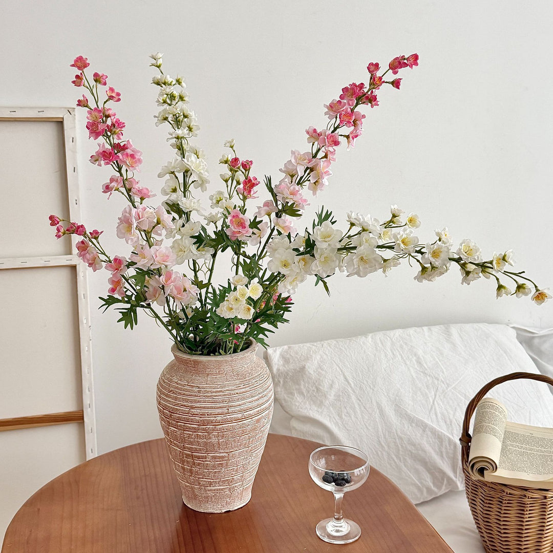 Artificial flower branch with intricately detailed red flowers