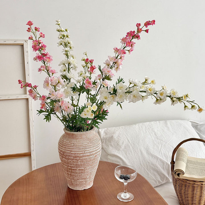 Artificial flower branch with intricately detailed red flowers