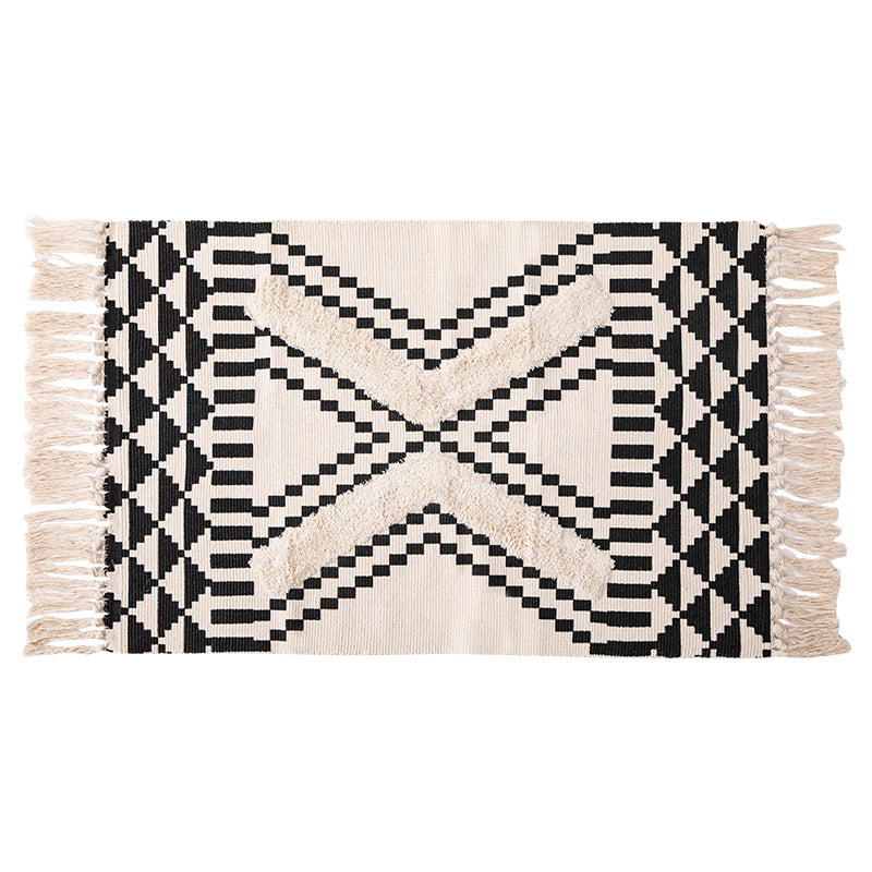 Hand-tufted bathroom mat with fringes, decorative dot-and-dash pattern and non-slip backing