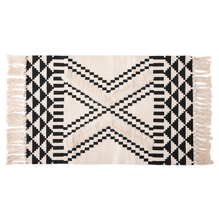 Hand-tufted bathroom mat with fringes, decorative dot-and-dash pattern and non-slip backing