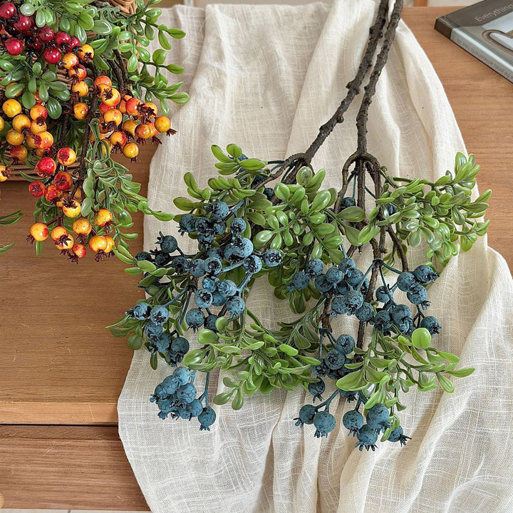 Artificial branch with glowing berries and green