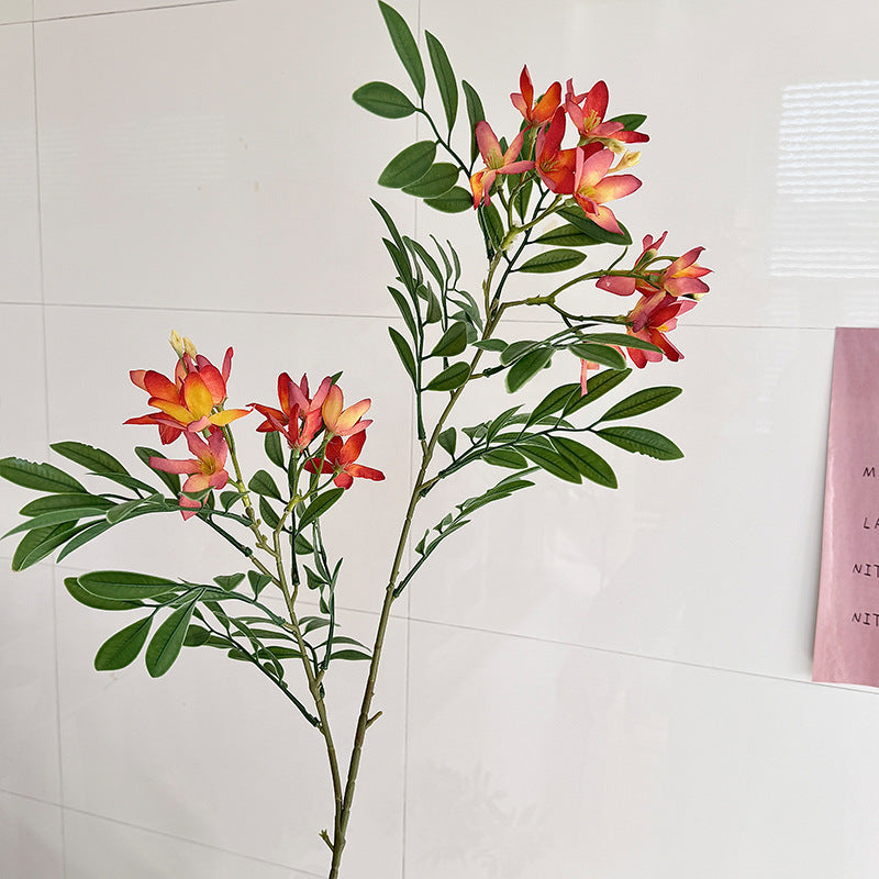 Decorative artificial flower branch with delicate flowers