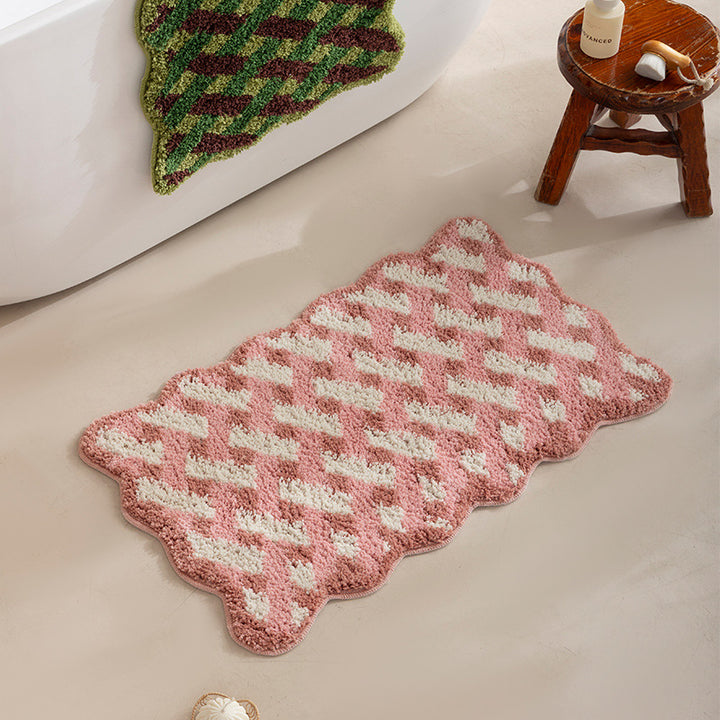 Tufted bathroom runner with wavy hem and relief-style braided pattern
