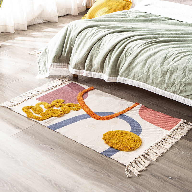 Hand-tufted bathroom mat with fringes, decorative dot-and-dash pattern and non-slip backing