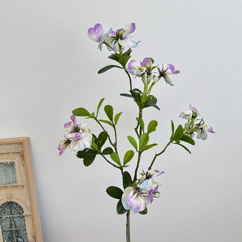 Artificial flower branch with vibrant pink flowers