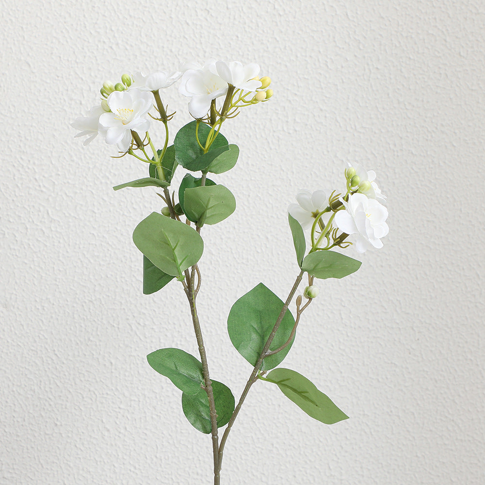 Artificial flower branch with vibrant pink flowers
