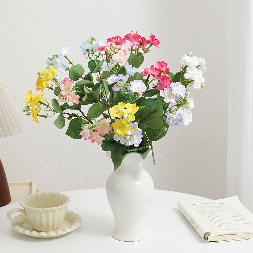Artificial flower branch with vibrant pink flowers