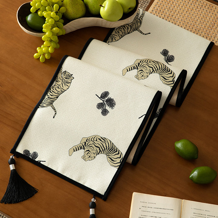 Woven cotton-linen table runner with tiger print and decorative tassels