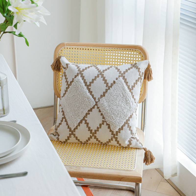 Decorative Boho cushion cover with hand-tufted diamond relief, tassels, and woven cotton blend