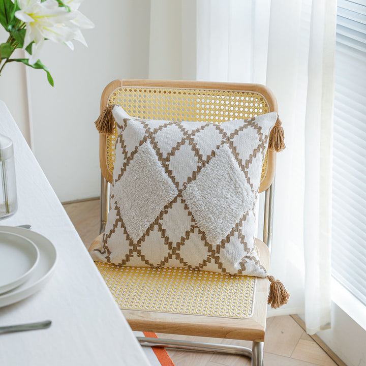 Decorative Boho cushion cover with hand-tufted diamond relief, tassels, and woven cotton blend
