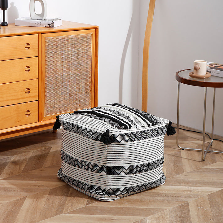 Braided square floor seat pouf with tassels and woven ethnic pattern