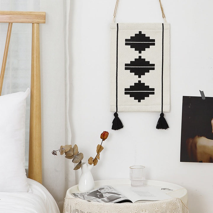 Woven wall hanging with graphic ethnic relief and tassels