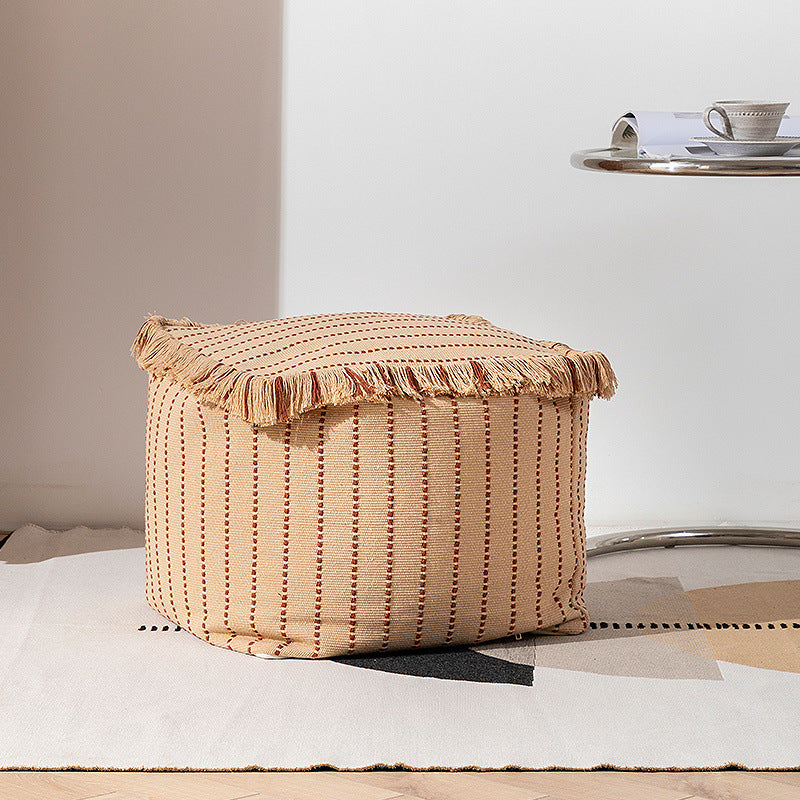 Woven decorative pouf with fringes and structured striped look
