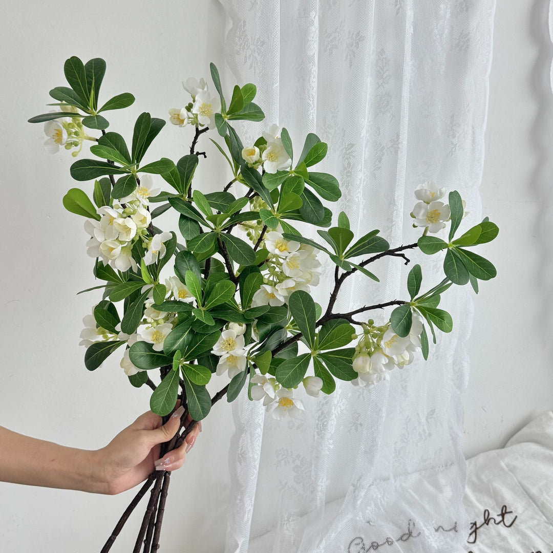 Artificial flower branch with fine pink flowers and vibrant leaves