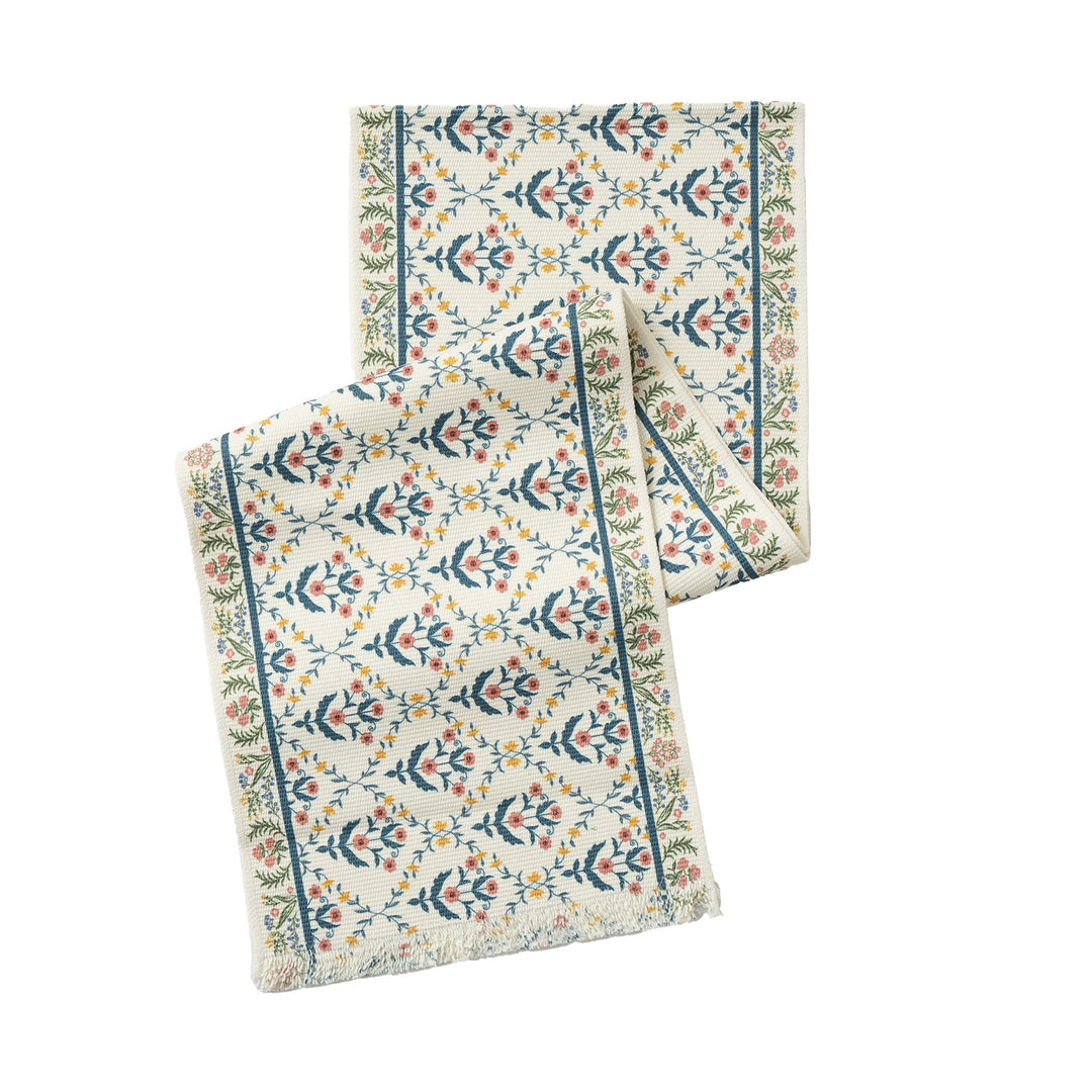 Vintage-inspired woven table runner with floral border and fringes