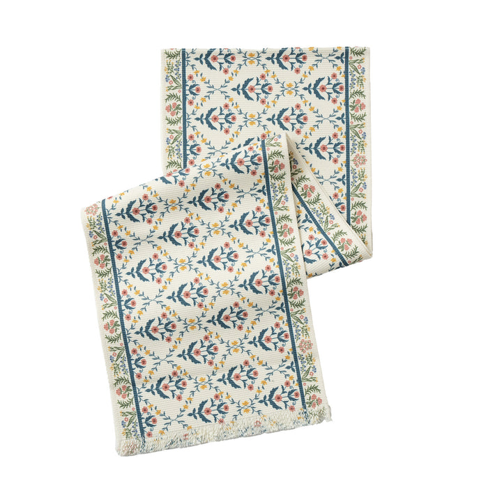 Vintage-inspired woven table runner with floral border and fringes