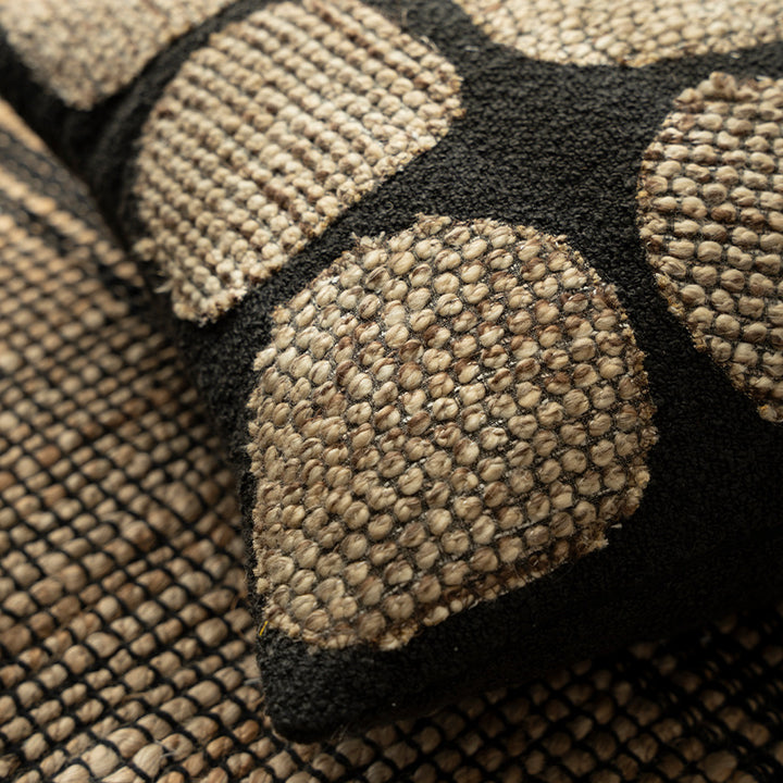 Decorative cushion cover made of textured bouclé weaving technique with raised round appliqués