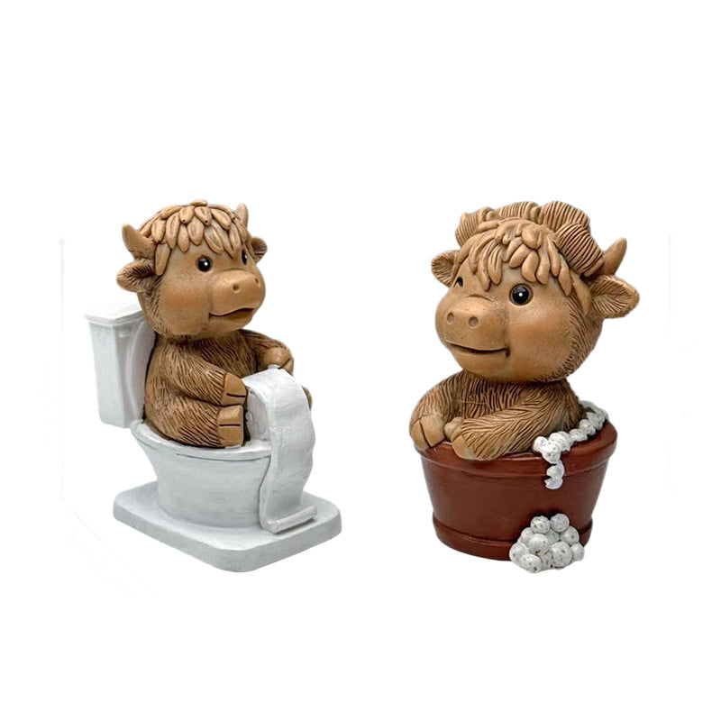 Funny decorative figure of a Highland cow on toilet