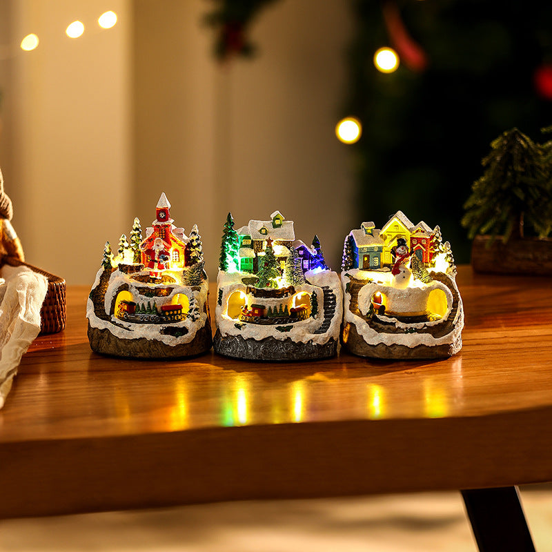 Illuminated Christmas village scene with snowman