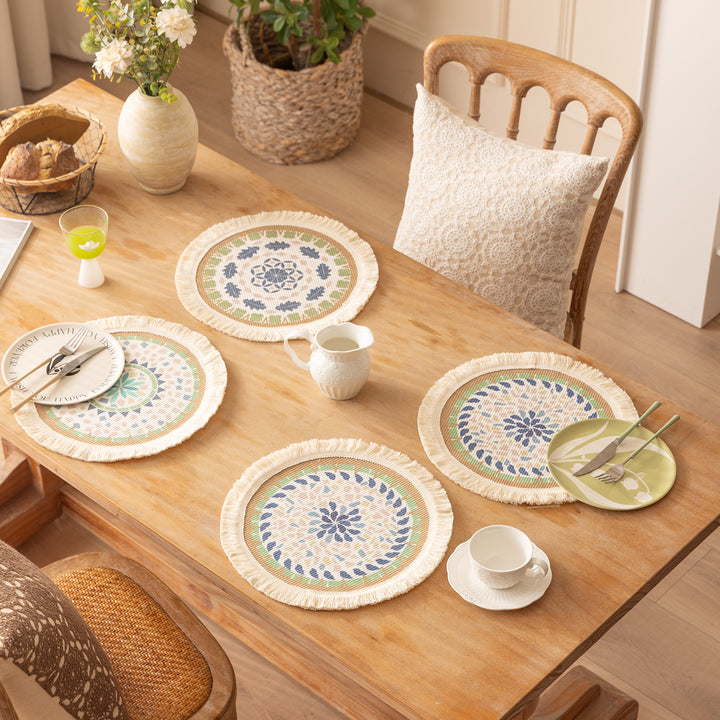 Round handmade woven decorative rug with fringes and botanical pattern