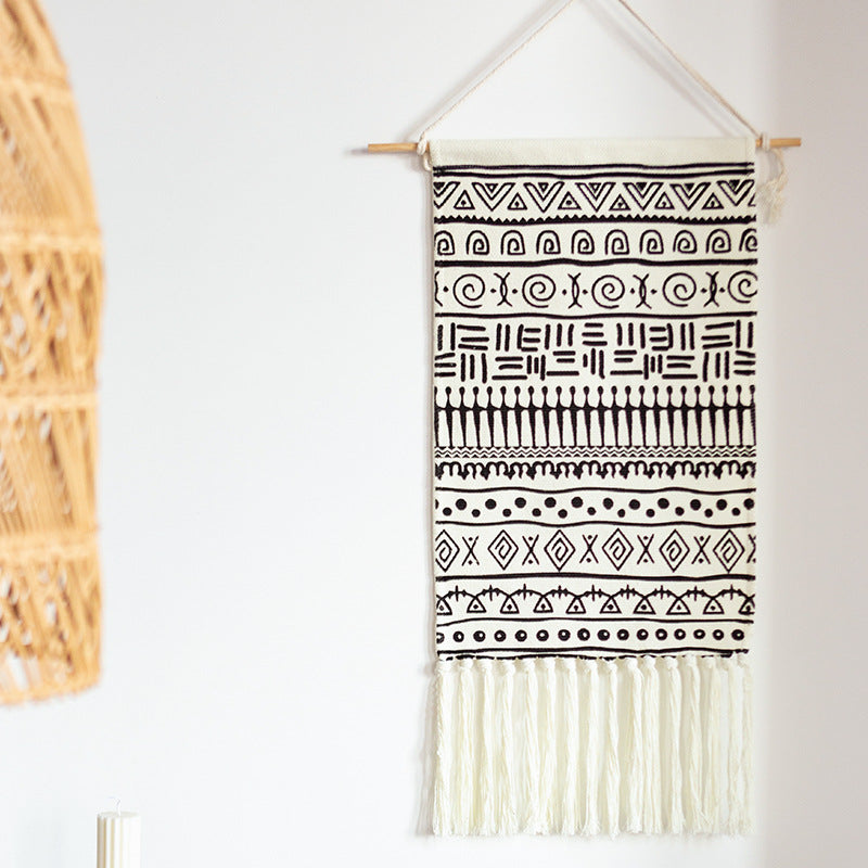 Woven cotton blend wall hanging with graphic ethnic pattern and long fringes