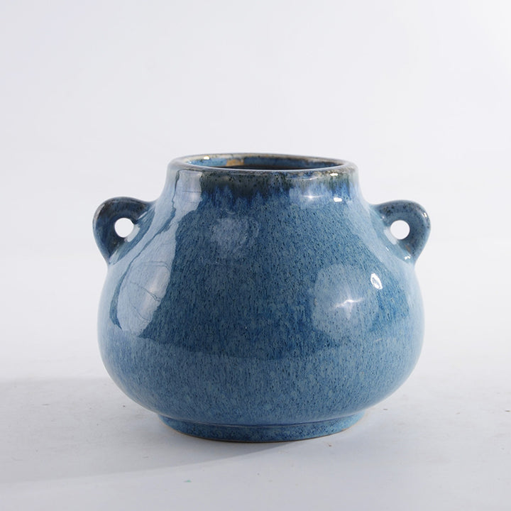 Decorative ceramic pot with playful handles