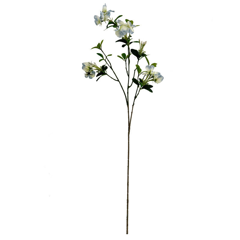 Artificial flower branch with vibrant pink flowers