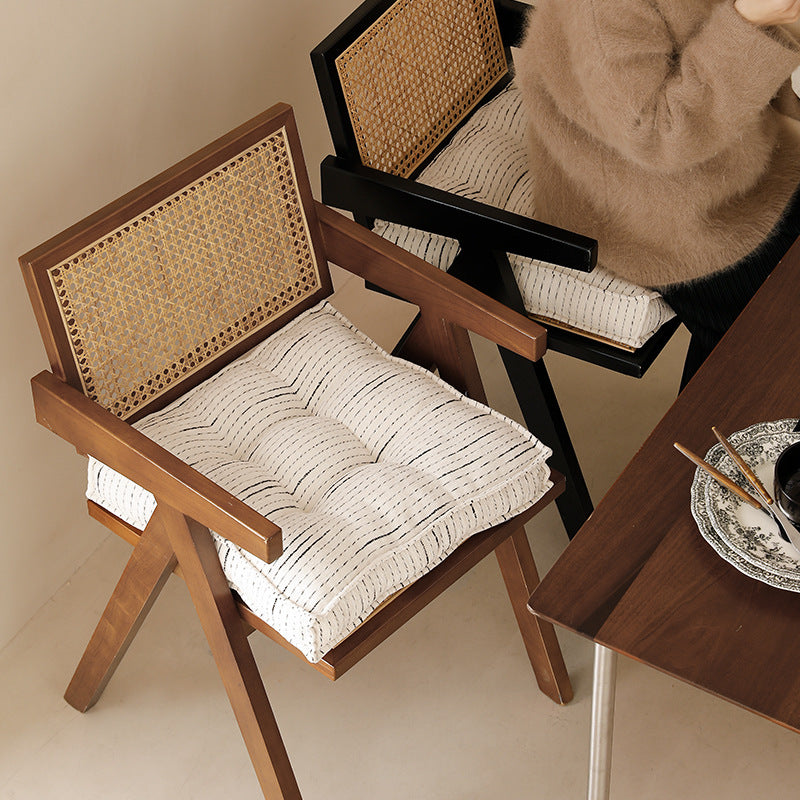 Padded square seat and floor cushion with quilted tufted padding and carrying handle
